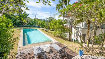 Backyard with swimming pool and lounge chairs