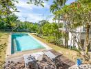 Backyard with swimming pool and lounge chairs