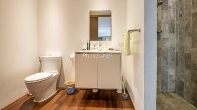 Modern bathroom with vanity, toilet, and shower