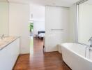 Modern bathroom with a bathtub, double sink vanity, and natural light