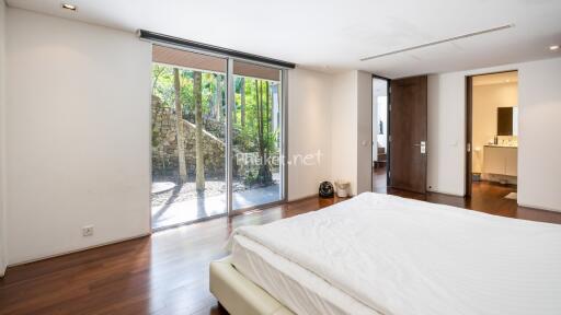 Modern bedroom with large window and hardwood floor