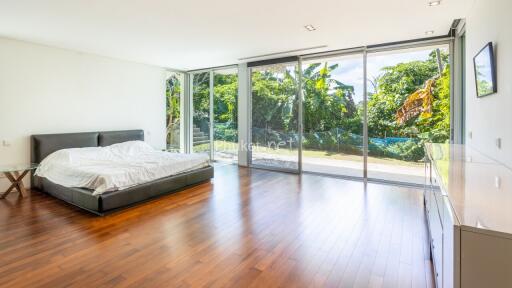 Spacious bedroom with large windows and outdoor view