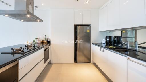 Modern kitchen with black granite countertop and stainless steel appliances