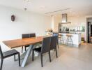 Modern kitchen and dining area with wooden table and black chairs
