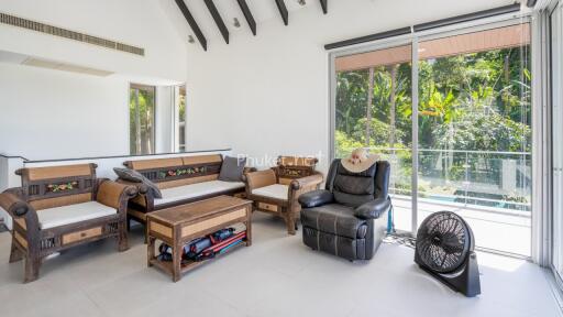 Spacious living room with large windows and balcony access