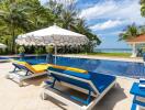 Outdoor pool area with loungers and umbrella