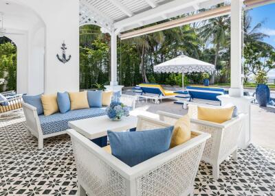 Outdoor seating area with pool and garden view