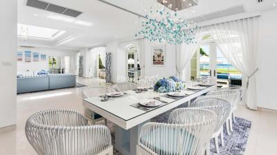 Elegant dining room with large table, stylish chairs, and beautiful chandelier