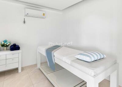 Simple room with massage bed and white furniture