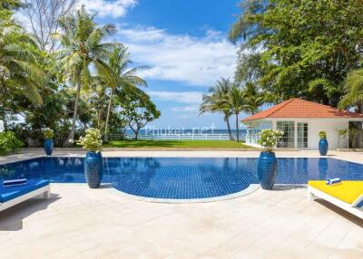 Tropical outdoor pool area with lounge chairs and ocean view