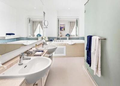 Spacious and modern bathroom with dual sinks and large mirror