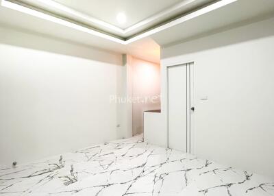 Spacious room with marble floor and modern lighting