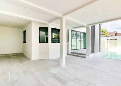 Covered patio area with tiled flooring and view of swimming pool