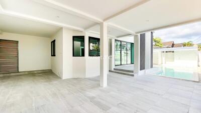 Covered patio area with tiled flooring and view of swimming pool