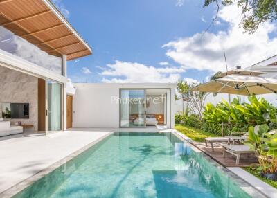 Outdoor swimming pool area with patio and garden