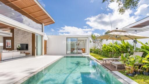 Outdoor swimming pool area with patio and garden