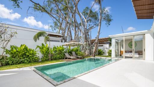 Outdoor area featuring a swimming pool and lush garden