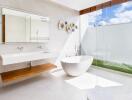 Modern bathroom with a freestanding bathtub and large glass shower