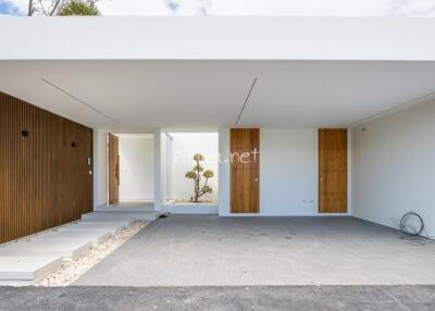 Modern minimalist building exterior with covered entryway
