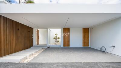 Modern minimalist building exterior with covered entryway