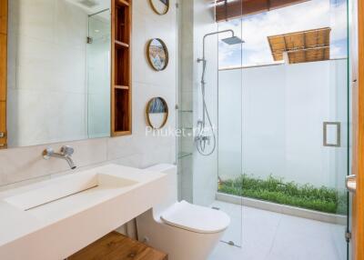 Modern bathroom with glass shower and wooden accents