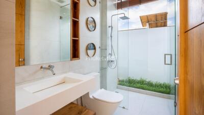 Modern bathroom with glass shower and wooden accents