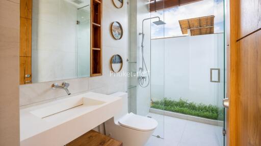 Modern bathroom with glass shower and wooden accents