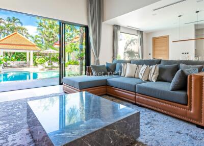 Bright living room with pool and garden view