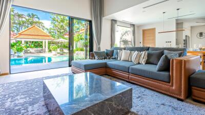 Bright living room with pool and garden view