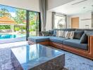 Bright living room with pool and garden view