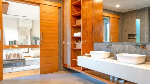 Modern bathroom with wooden accents and dual sinks