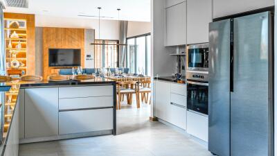 Modern kitchen with dining area in the background