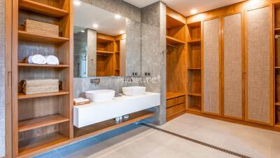 Modern bathroom with double sink and wooden storage