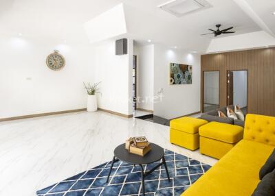 Modern living room with yellow sofa and decorative elements