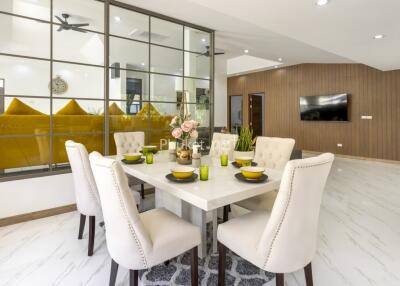 Modern dining area with table setting and view into living room