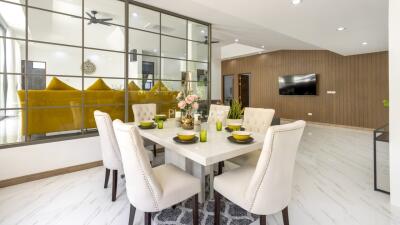 Modern dining area with table setting and view into living room