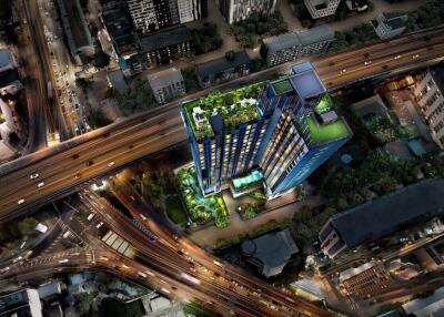 Aerial view of a modern building with rooftop gardens and surrounding cityscape