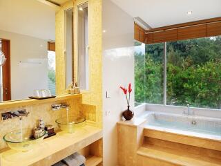 Luxury bathroom with double sinks and a scenic view