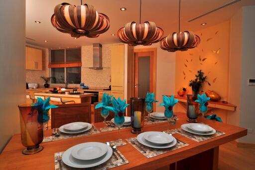 Modern kitchen with dining table, decorative lights, and contemporary decor