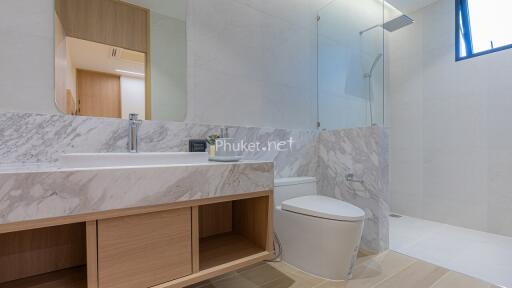 Modern bathroom with marble countertops and walk-in shower