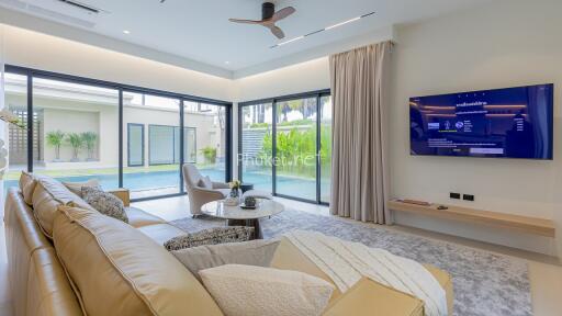 Modern living room with large windows and pool view