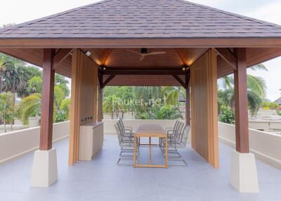 Outdoor seating area with table under a pavilion roof