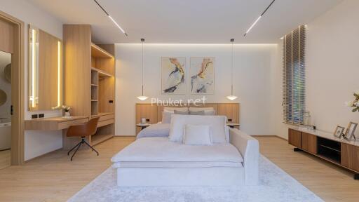 Spacious and modern bedroom with desk and seating area