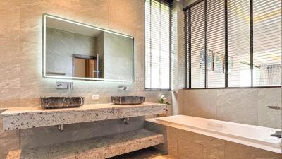 Modern bathroom with double sinks and bathtub