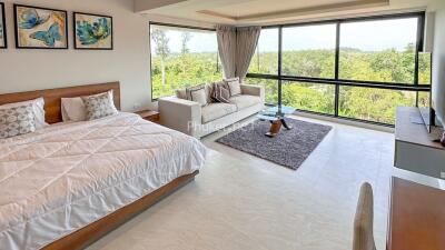 Spacious bedroom with a large window and a scenic view