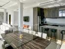 Modern kitchen with dining area featuring marble-top table and sleek bar stools