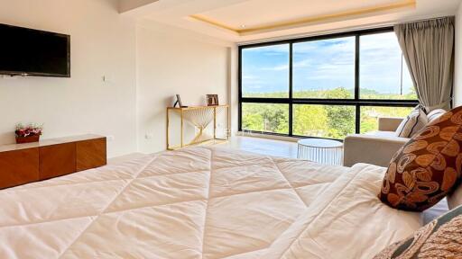 Bright bedroom with large window and scenic view
