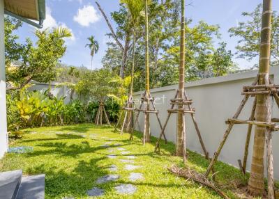 Beautiful garden with tropical trees and a stone pathway