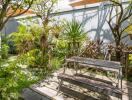 Serene outdoor garden area with picnic bench and lush greenery