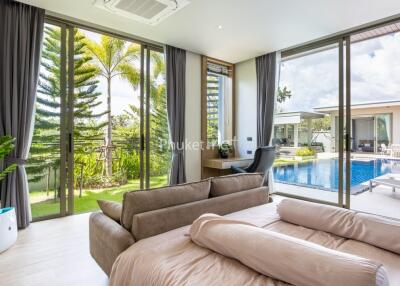 Living room with sliding glass doors and view of pool and garden